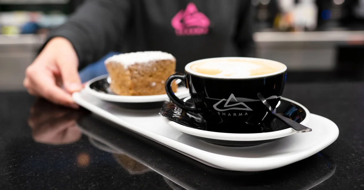 Team building ideas in Madrid for teams enjoying a social moment with coffee and catering at the bar